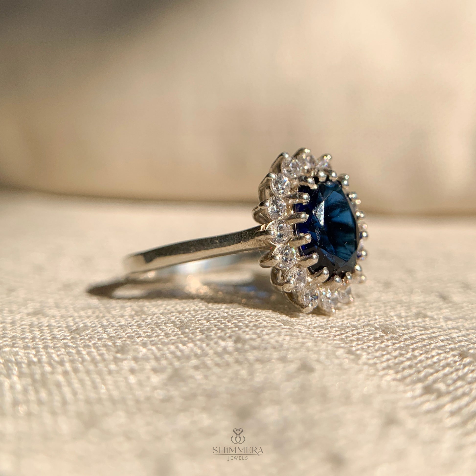 Vintage style oval cut blue sapphire ring with side stones