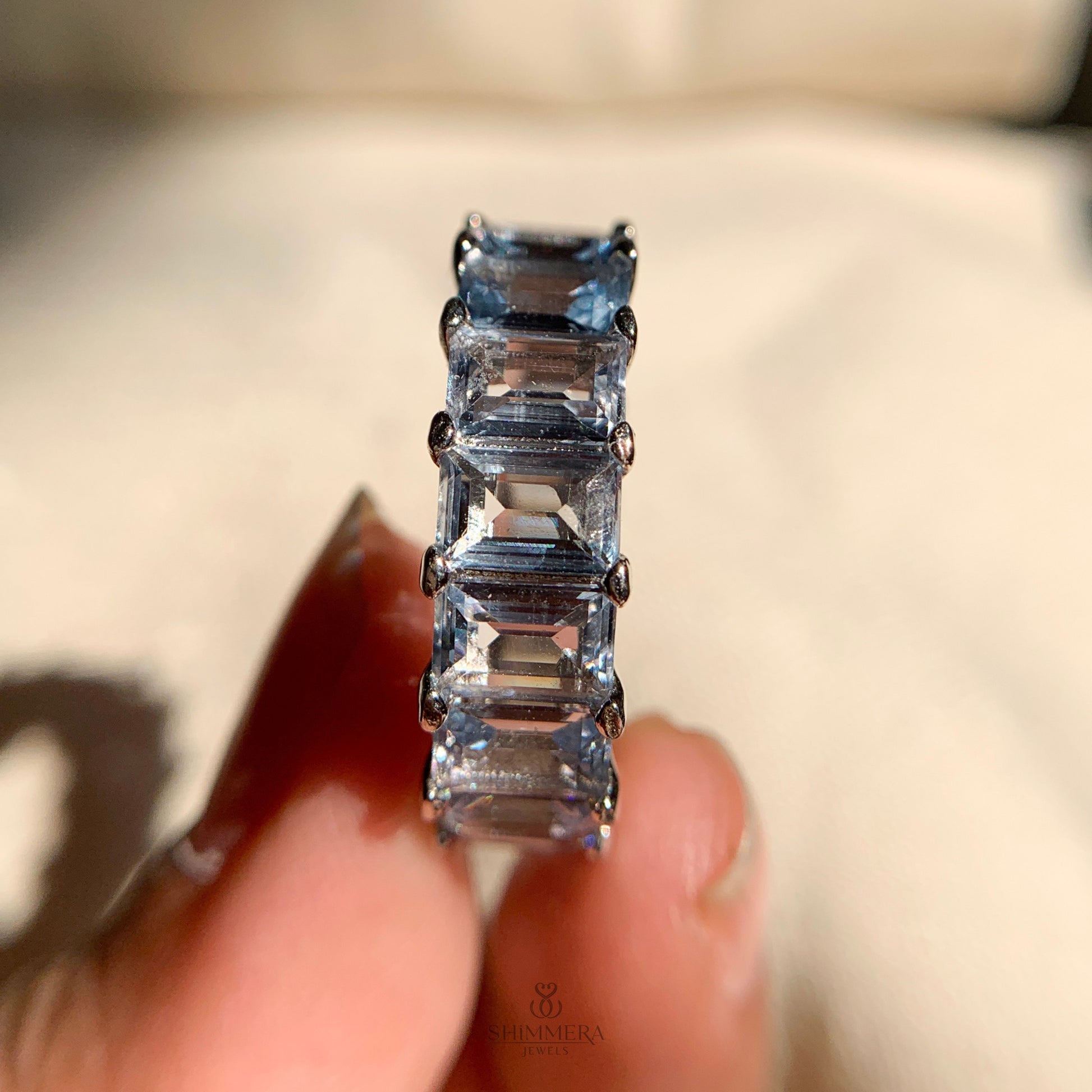 Elegant rose gold band featuring round aquamarine stones all around