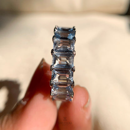 Elegant rose gold band featuring round aquamarine stones all around