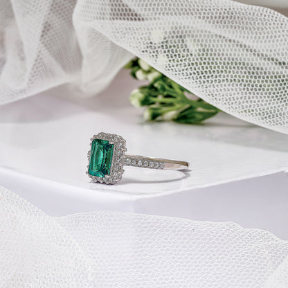 Modern Emerald and Diamond Halo Engagement Ring