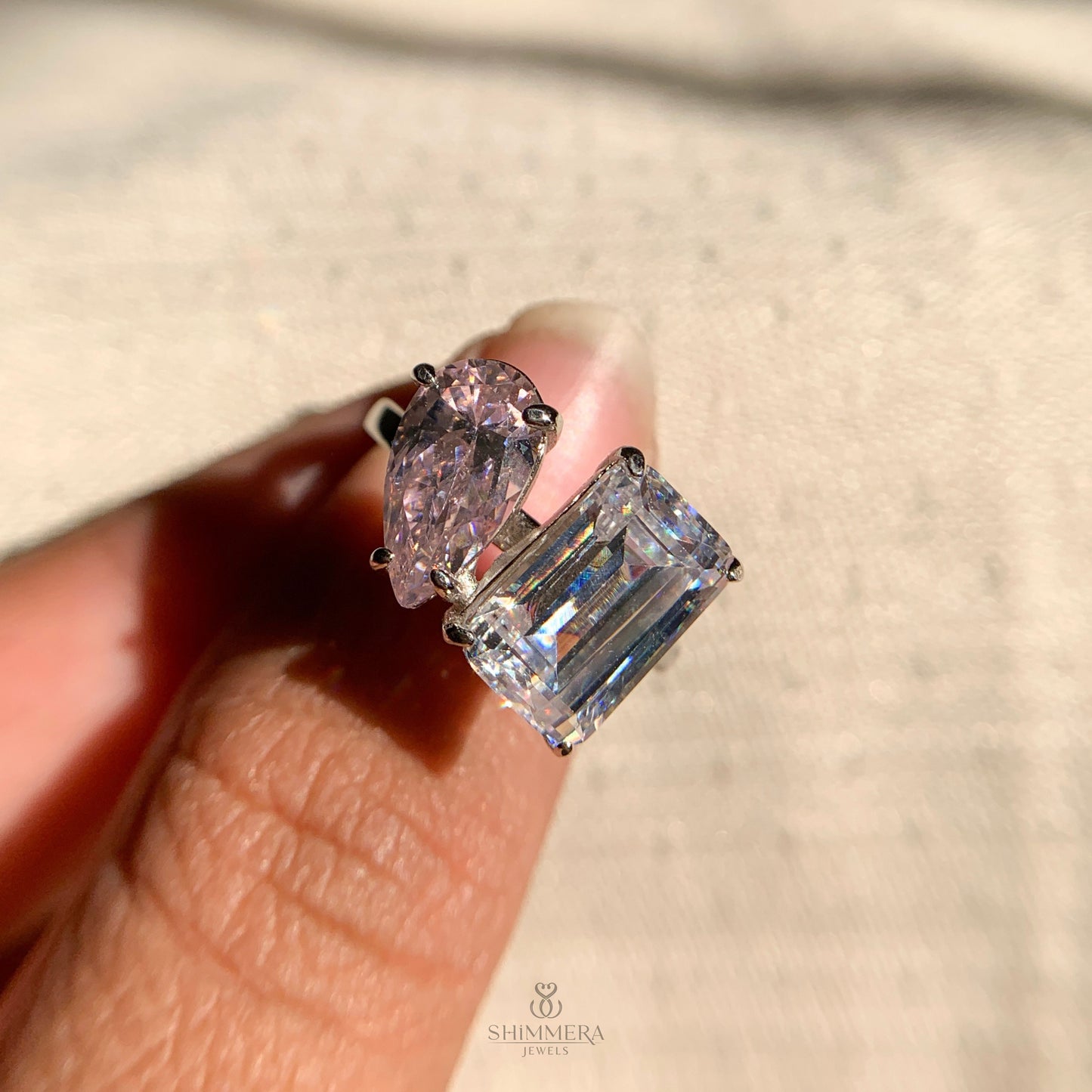 Elegant emerald cut and pear shaped diamond engagement ring for women