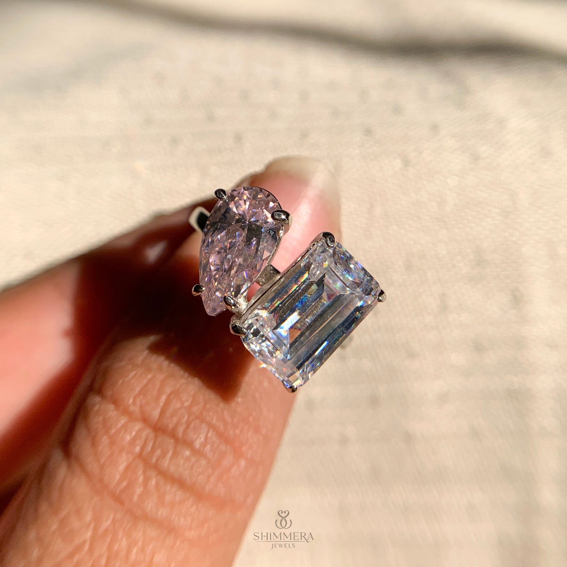 Elegant emerald cut and pear shaped diamond engagement ring for women