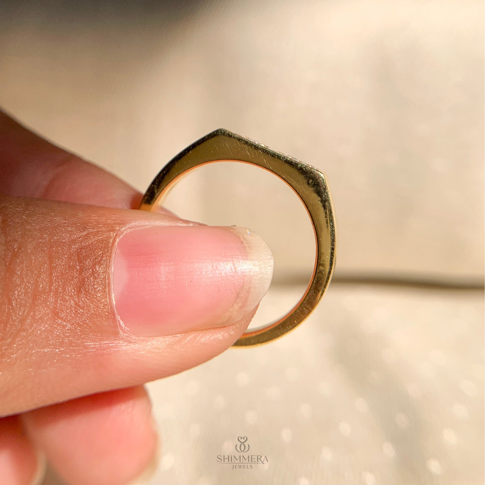 Dainty yellow gold band with five round brilliant diamonds