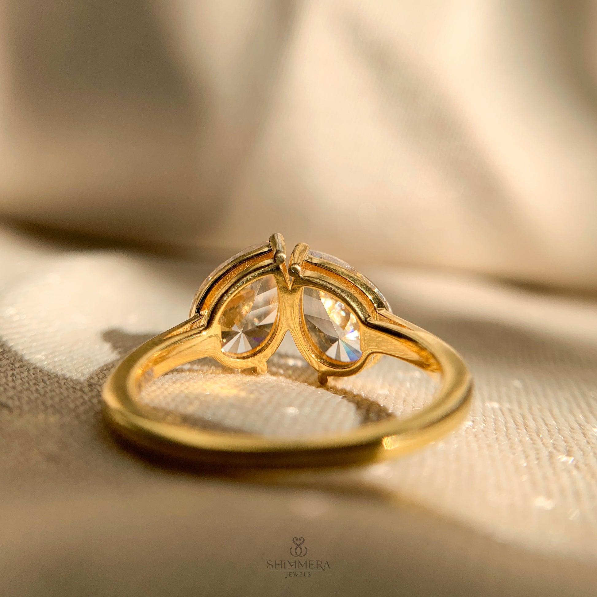 Unique two stone engagement ring with pear cut moissanite brilliance