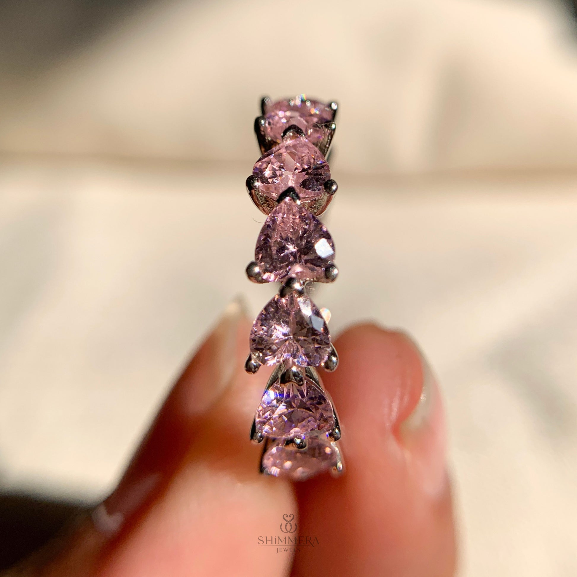 Elegant pink colored diamond heart eternity band, perfect for weddings