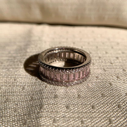 Dainty pink baguette eternity band in polished white gold finish