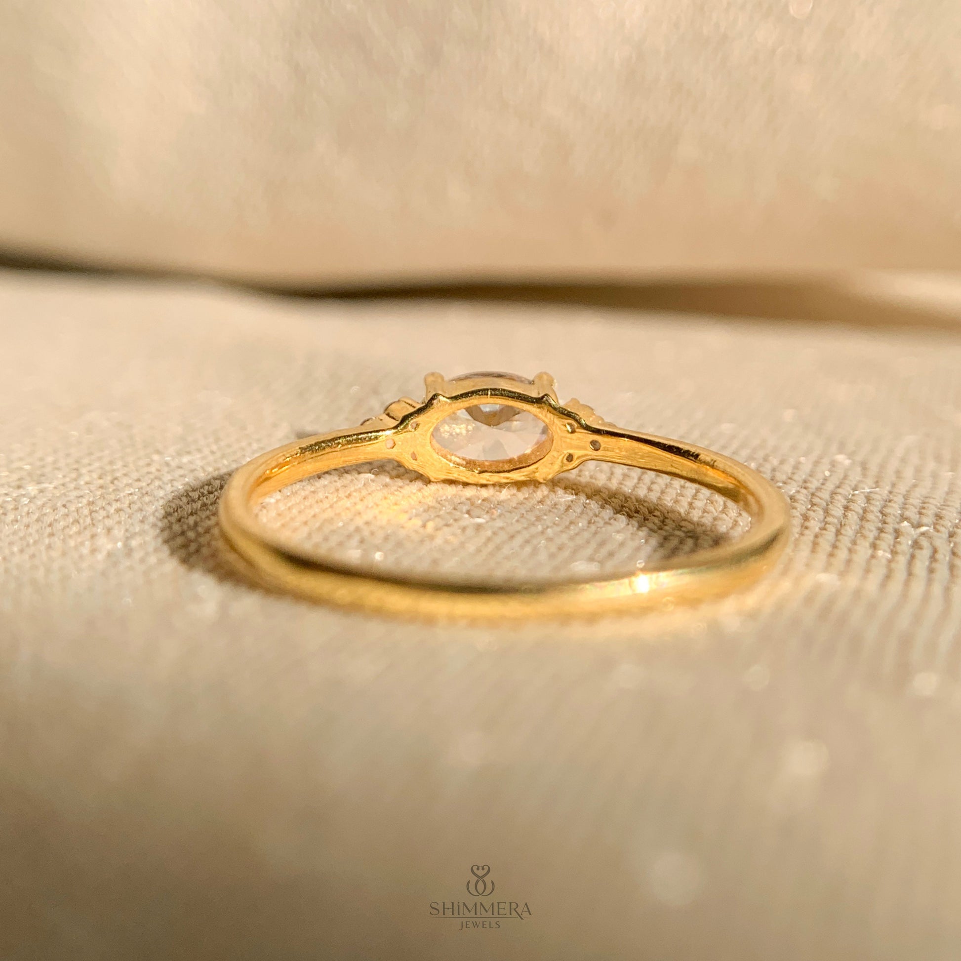 Timeless oval diamond ring in horizontal setting with gold shank