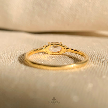 Timeless oval diamond ring in horizontal setting with gold shank