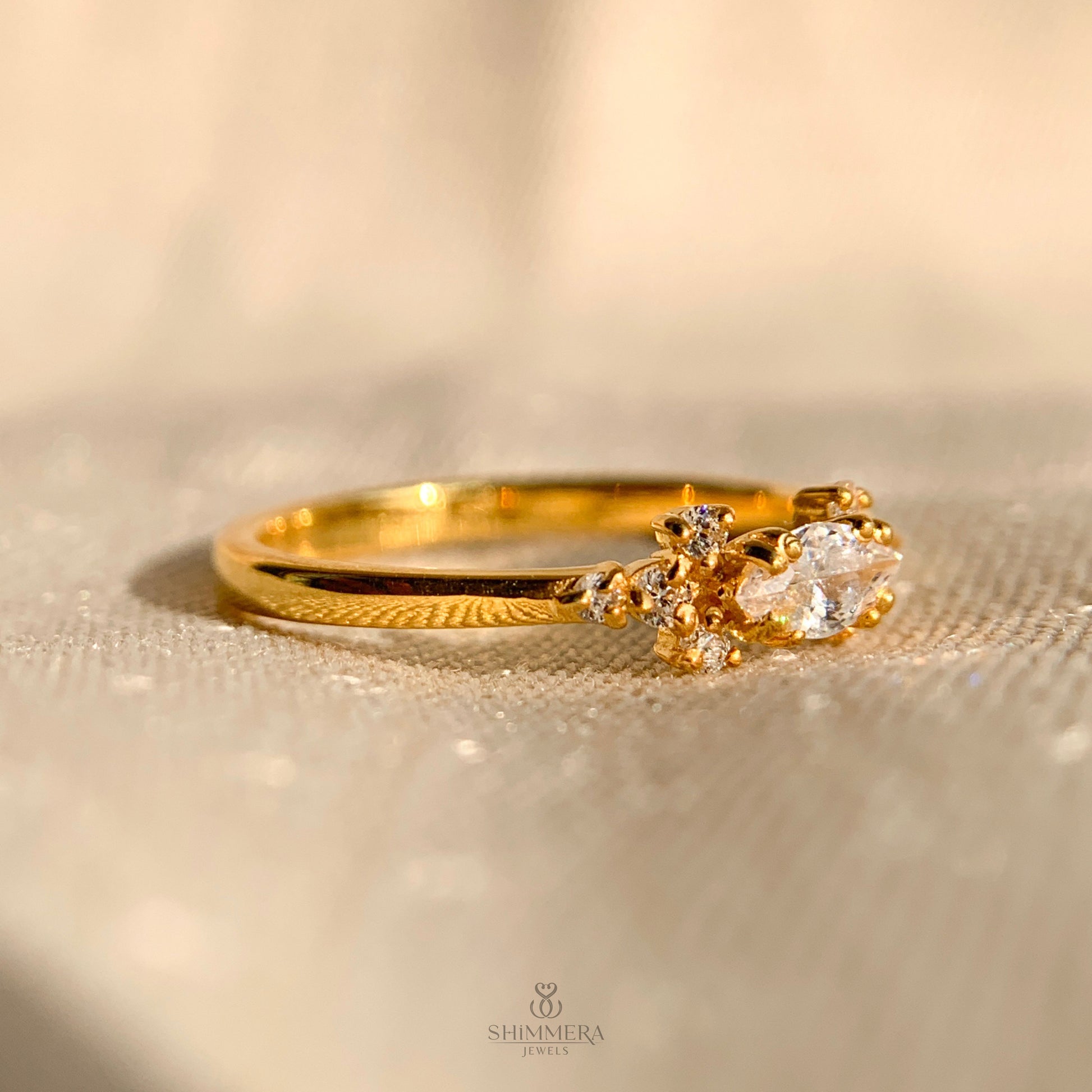 Unique engagement ring with round center diamond and marquise accents