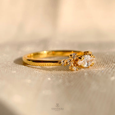 Unique engagement ring with round center diamond and marquise accents