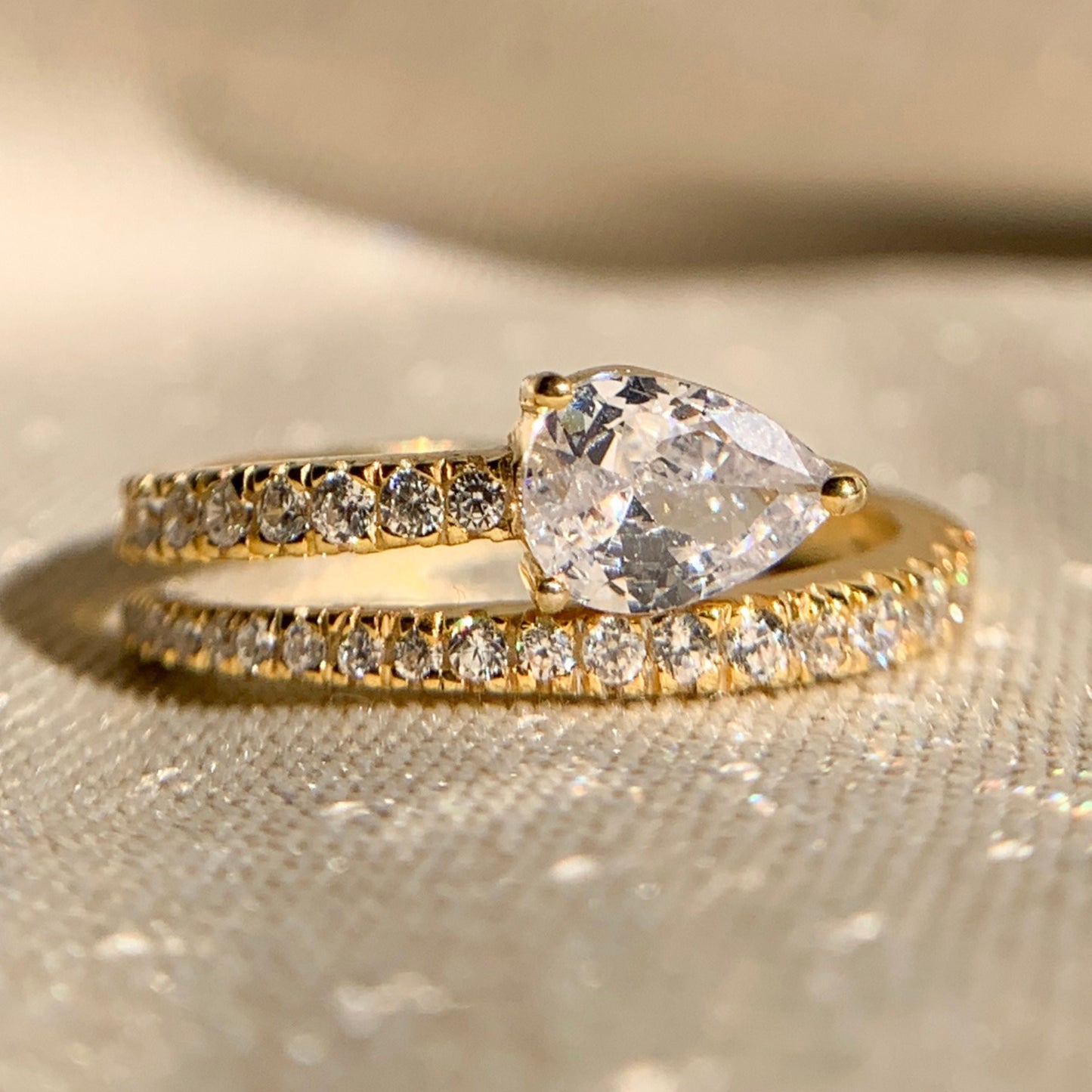 Pear cut lab diamond side stone anniversary ring in white gold
