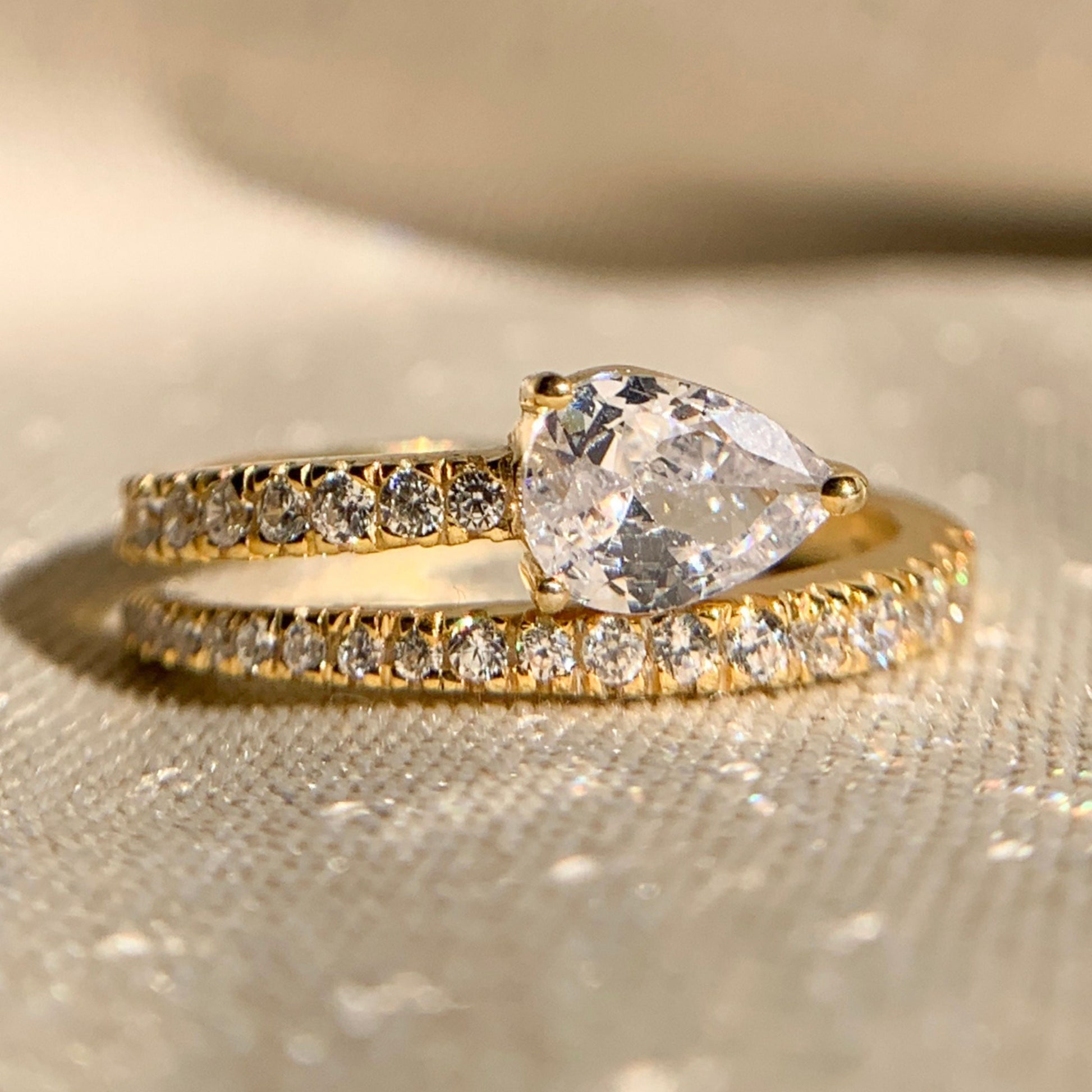 Pear cut lab diamond side stone anniversary ring in white gold
