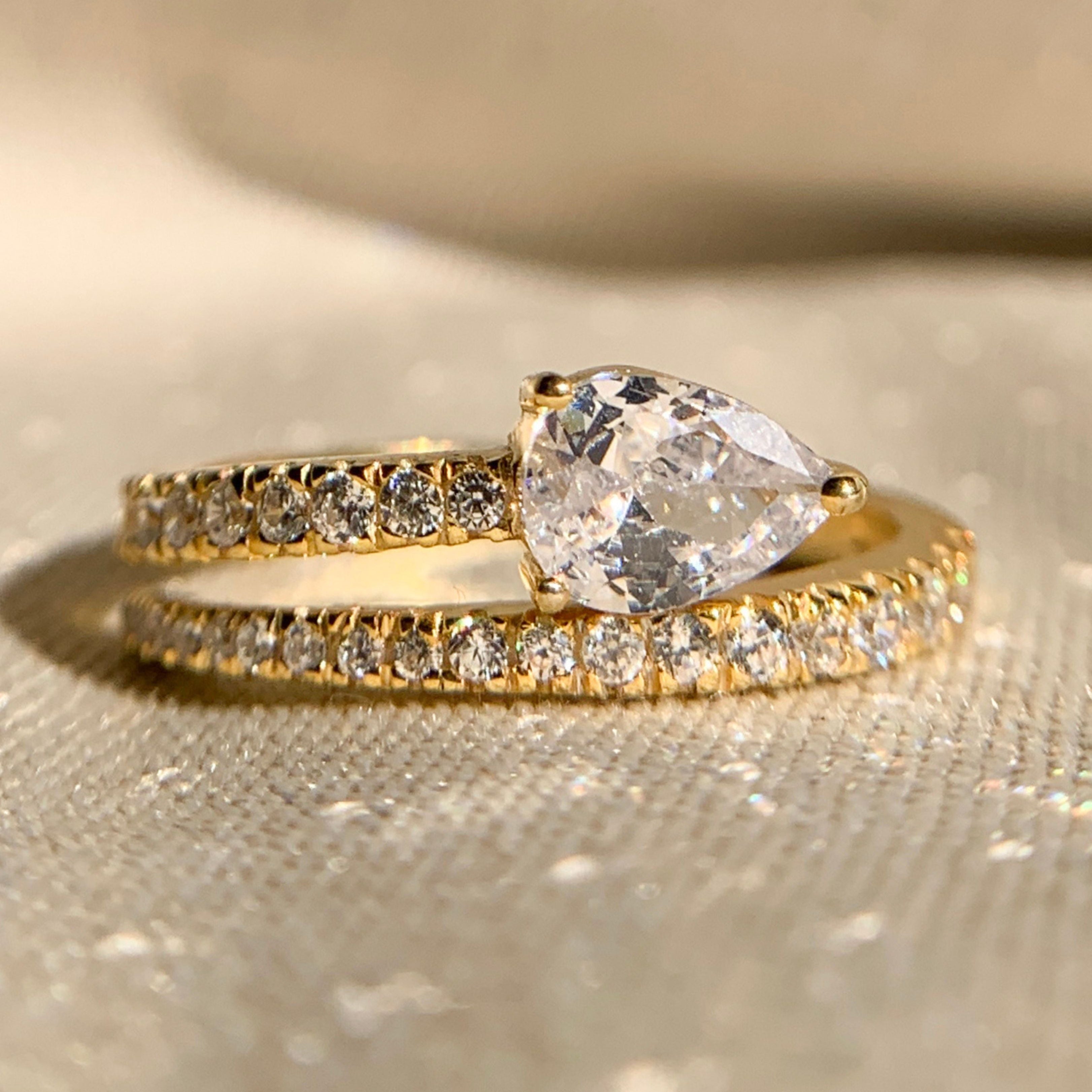 Pear cut lab diamond side stone anniversary ring in white gold