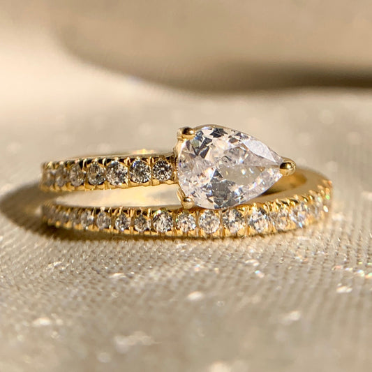Pear cut lab diamond side stone anniversary ring in white gold