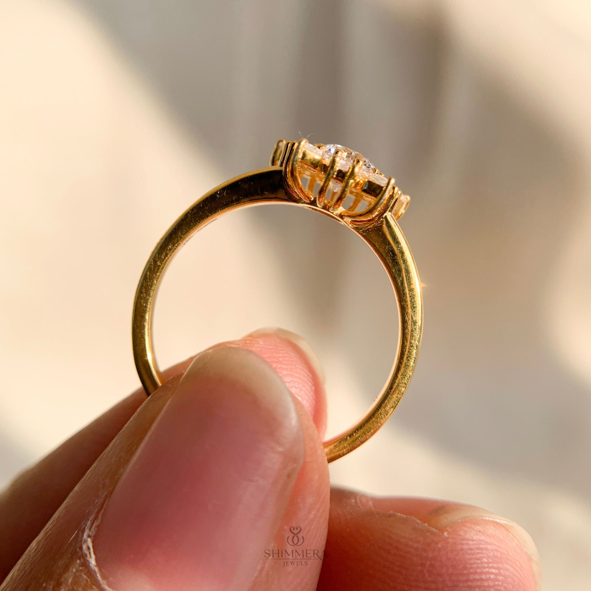 Timeless diamond cluster engagement ring featuring round and pear stones