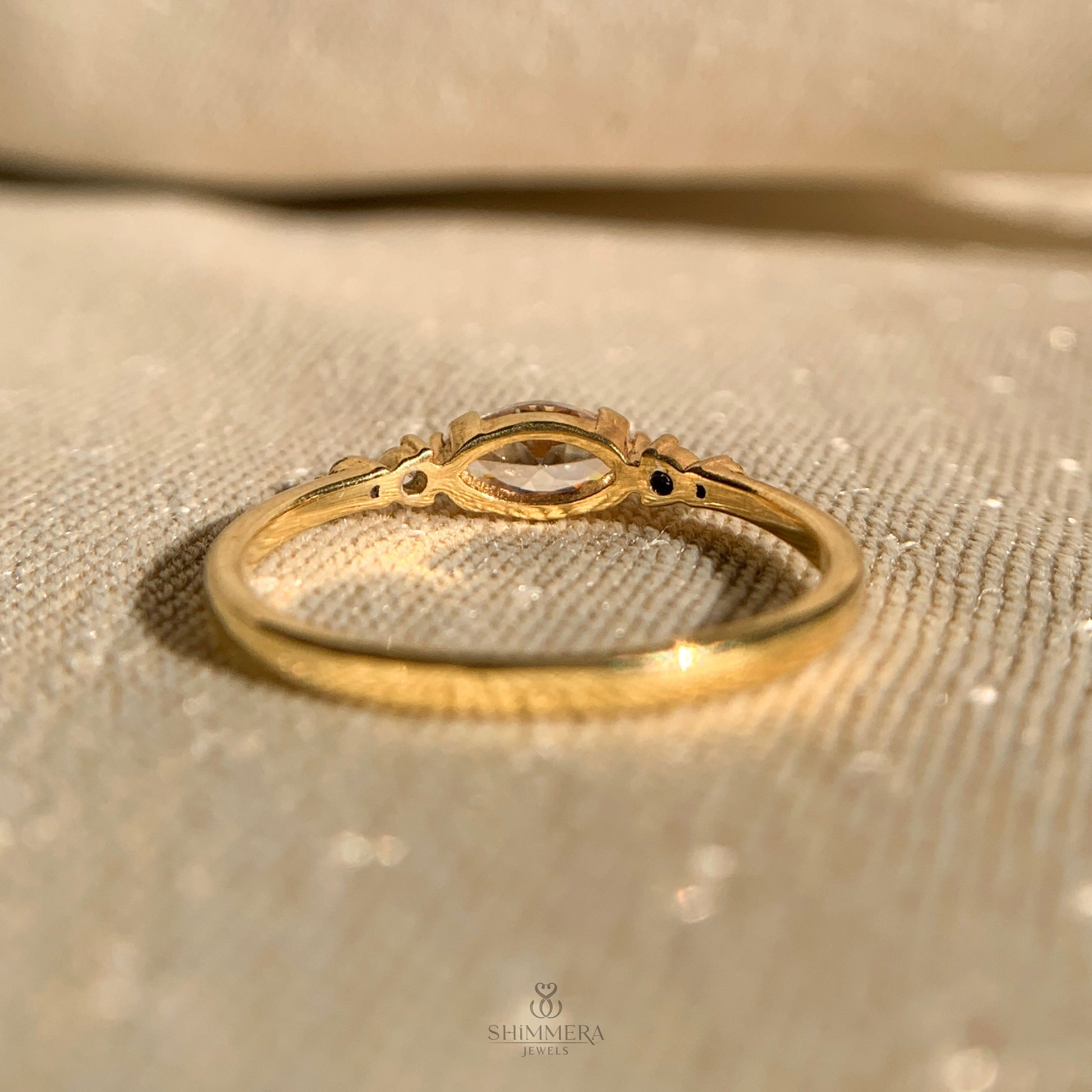 Modern east-west marquise diamond engagement ring in yellow gold