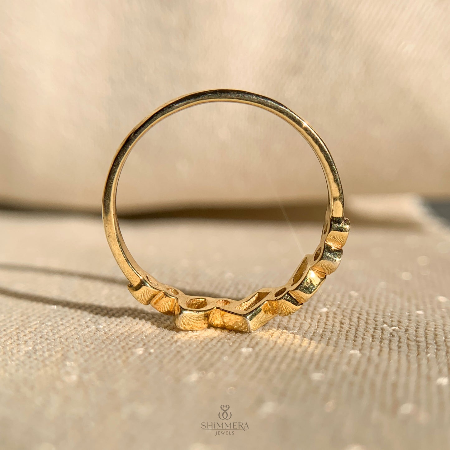 Stylish wedding band featuring bezel set round and oval diamonds