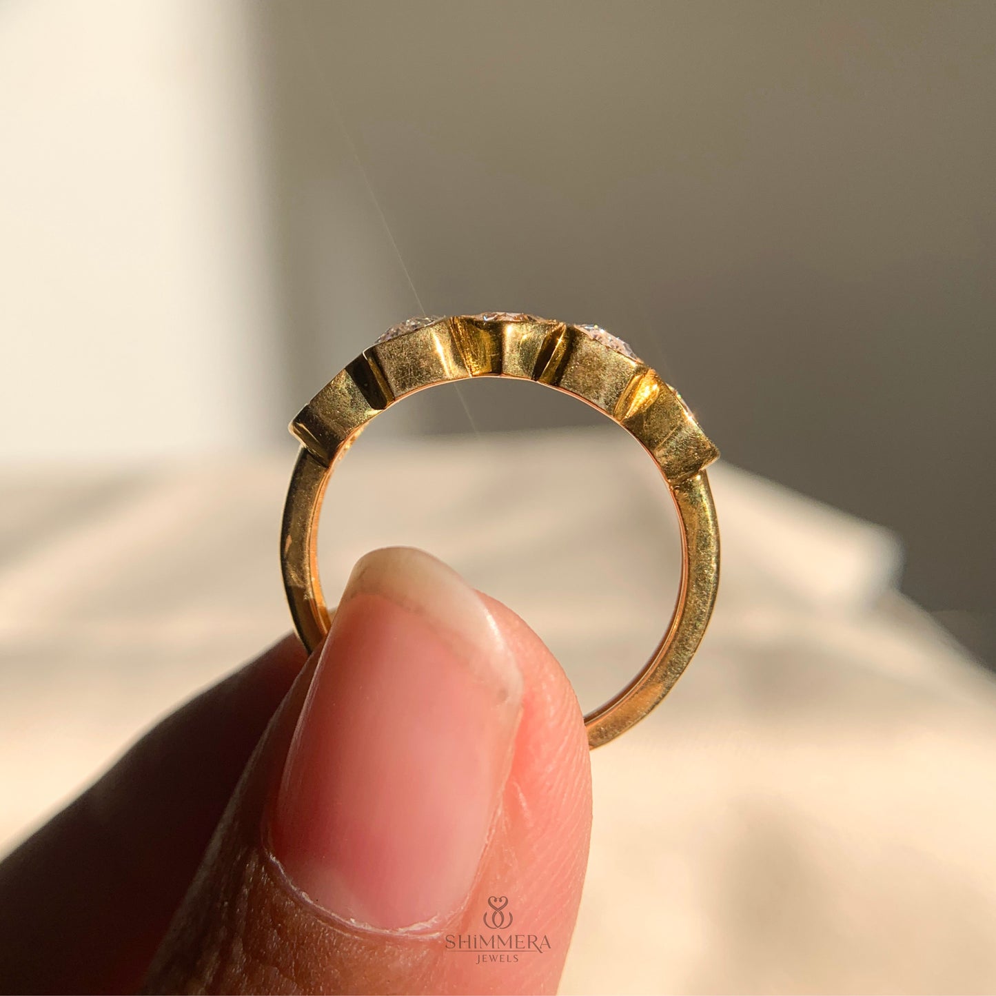 Modern bezel diamond wedding band in yellow gold finish