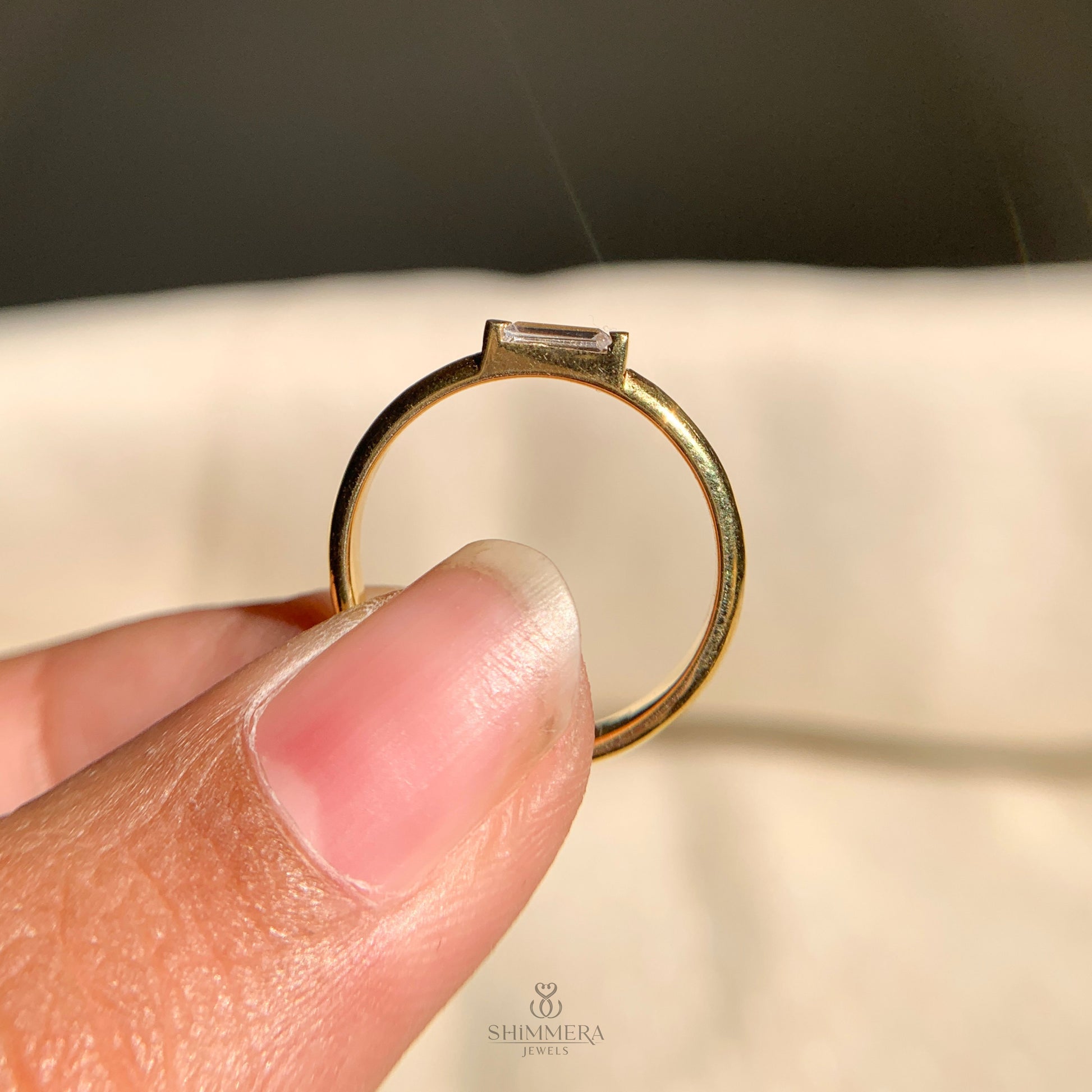 Modern solitaire baguette diamond band in east-west orientation