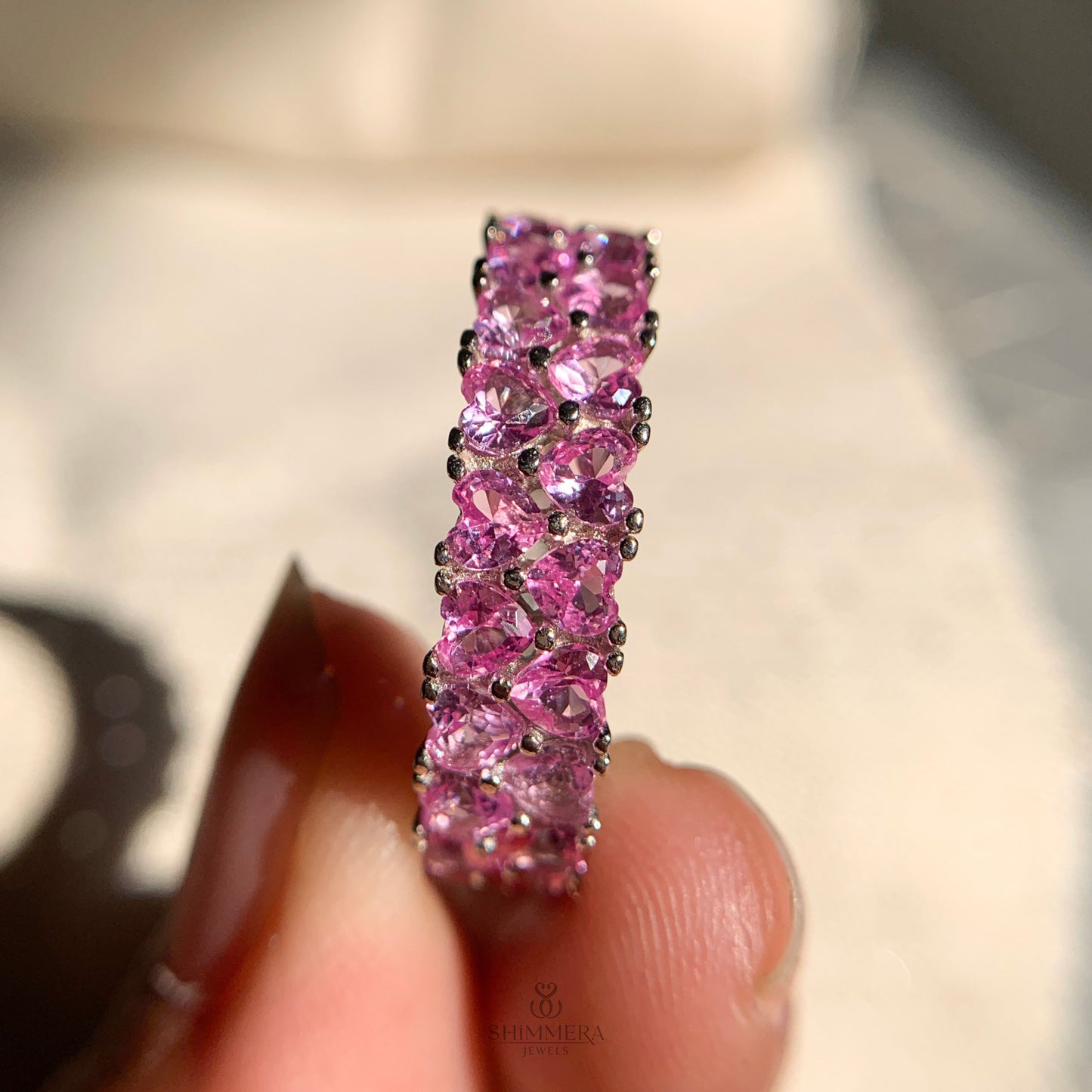 Dainty pink heart shaped diamond band stacked with wedding rings