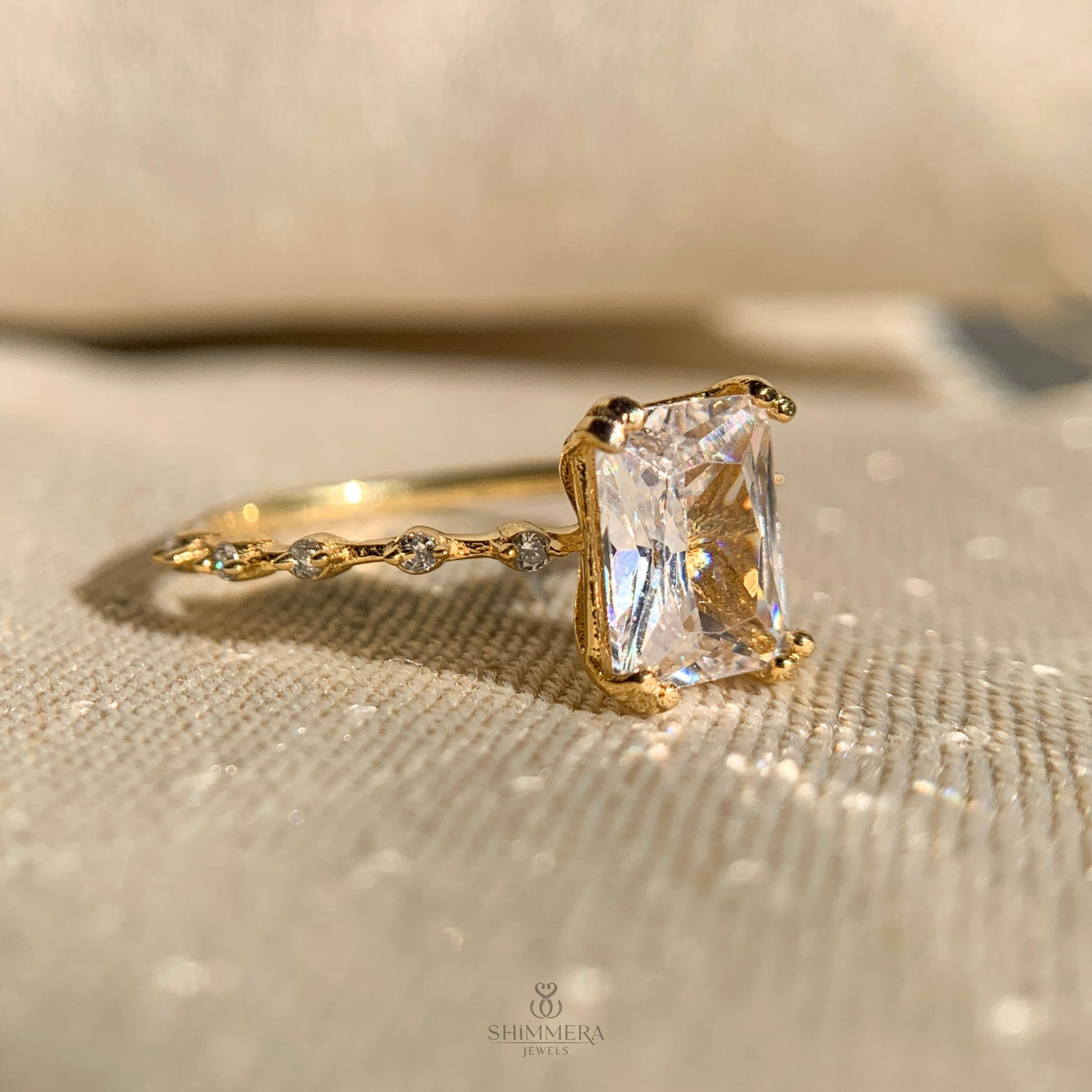 Radiant cut solitaire style ring enhanced with side diamonds for extra brilliance