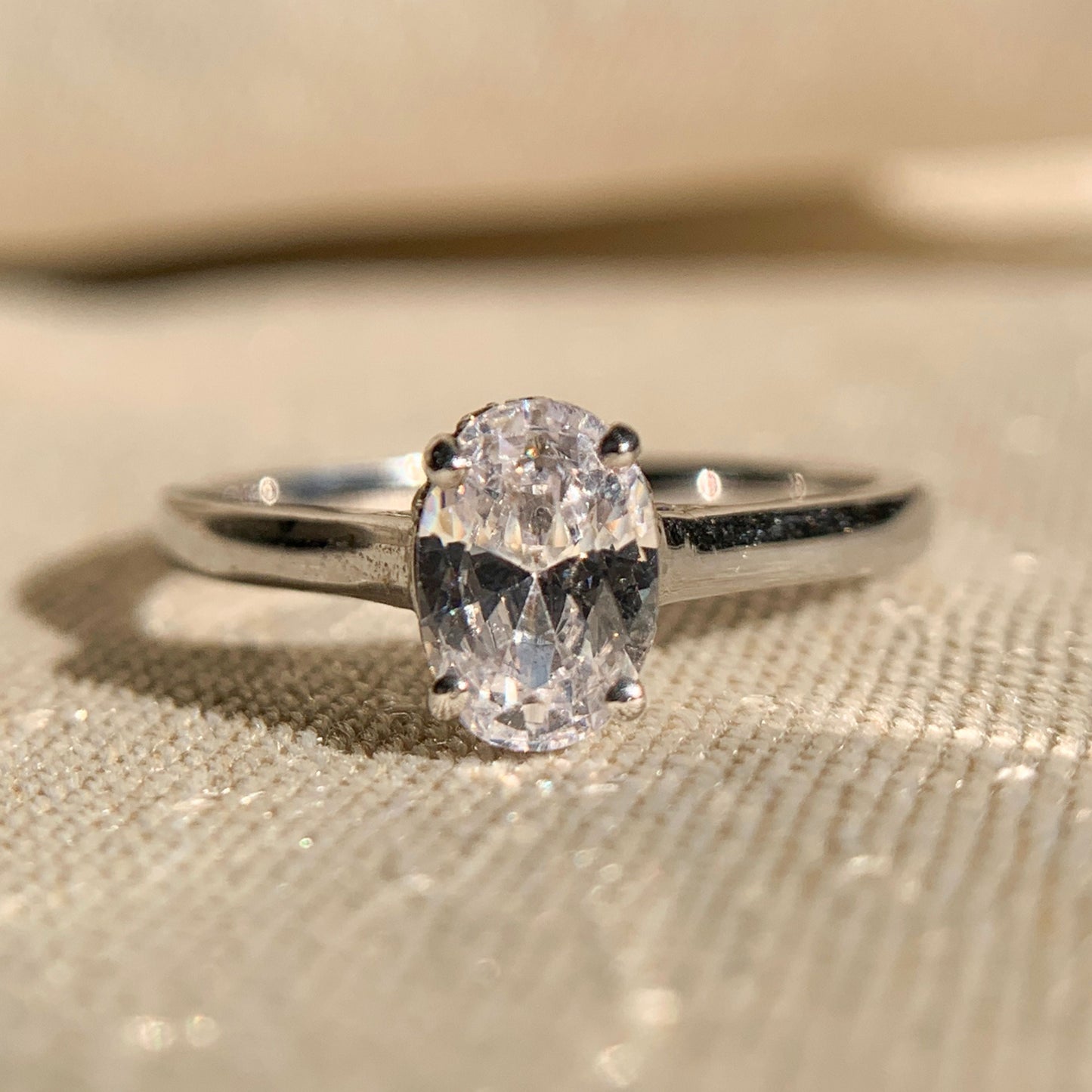14k white gold oval cut solitaire engagement ring on display