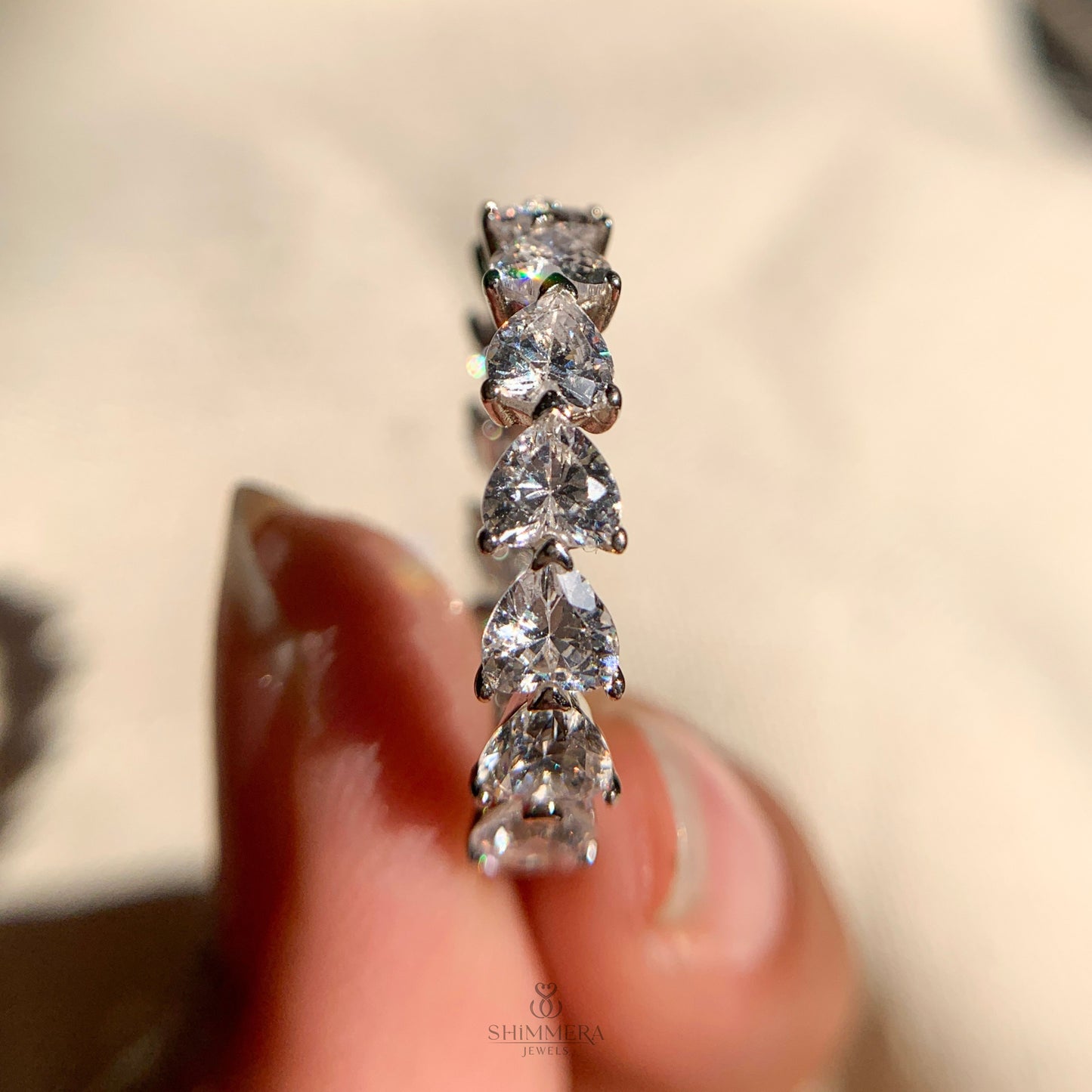 Sparkling moissanite heart diamond eternity band close-up