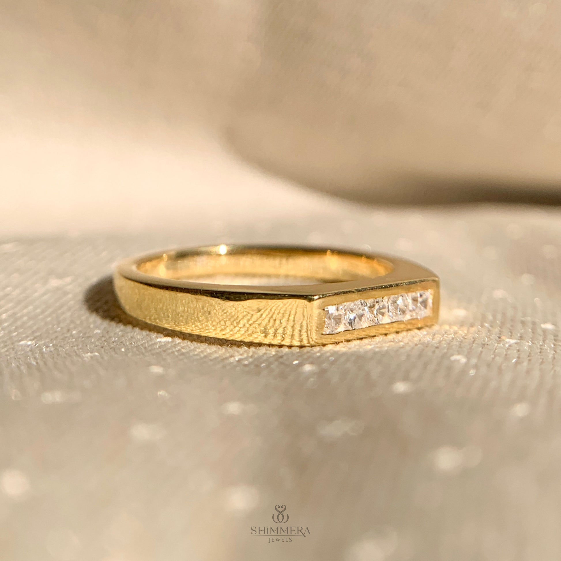 Timeless five stone gold wedding ring featuring sparkling diamonds