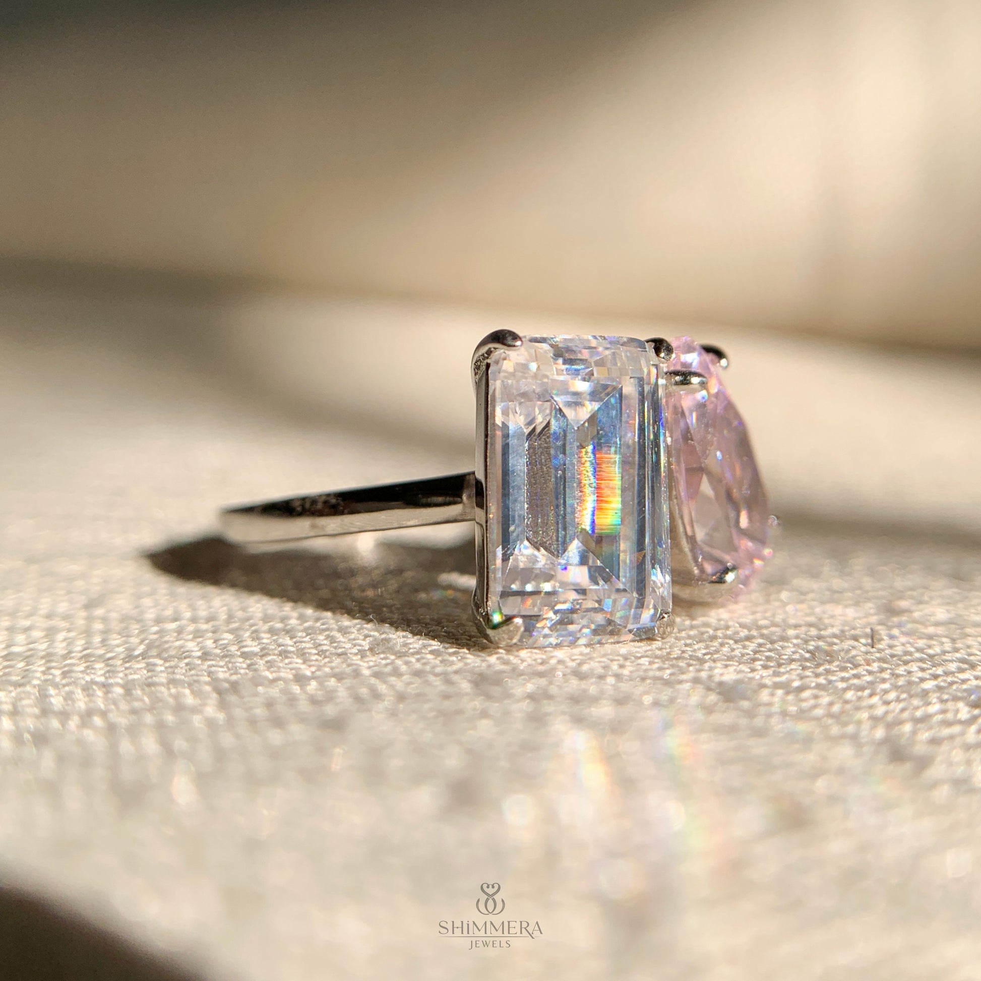 Classic double diamond engagement ring with emerald and pear stones