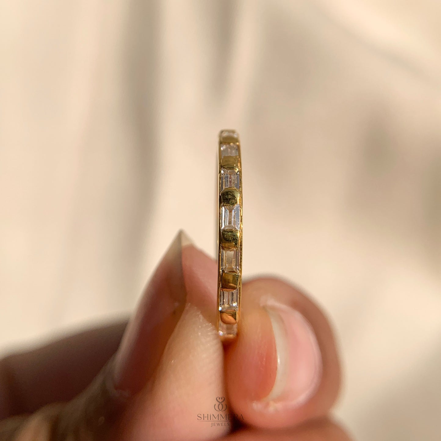 Modern east west baguette wedding band crafted in 14k yellow gold