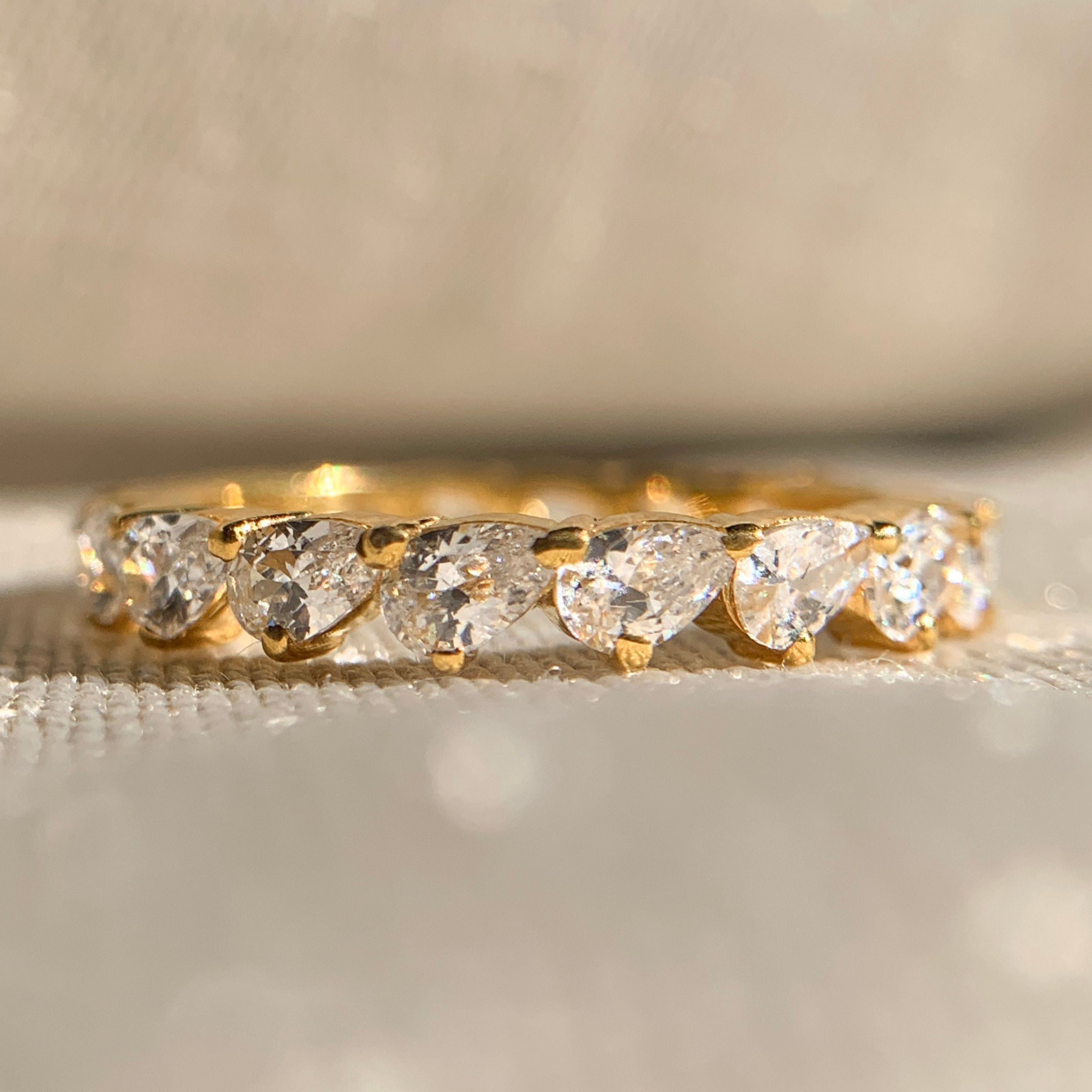 Elegant moissanite pear diamond eternity band in white gold