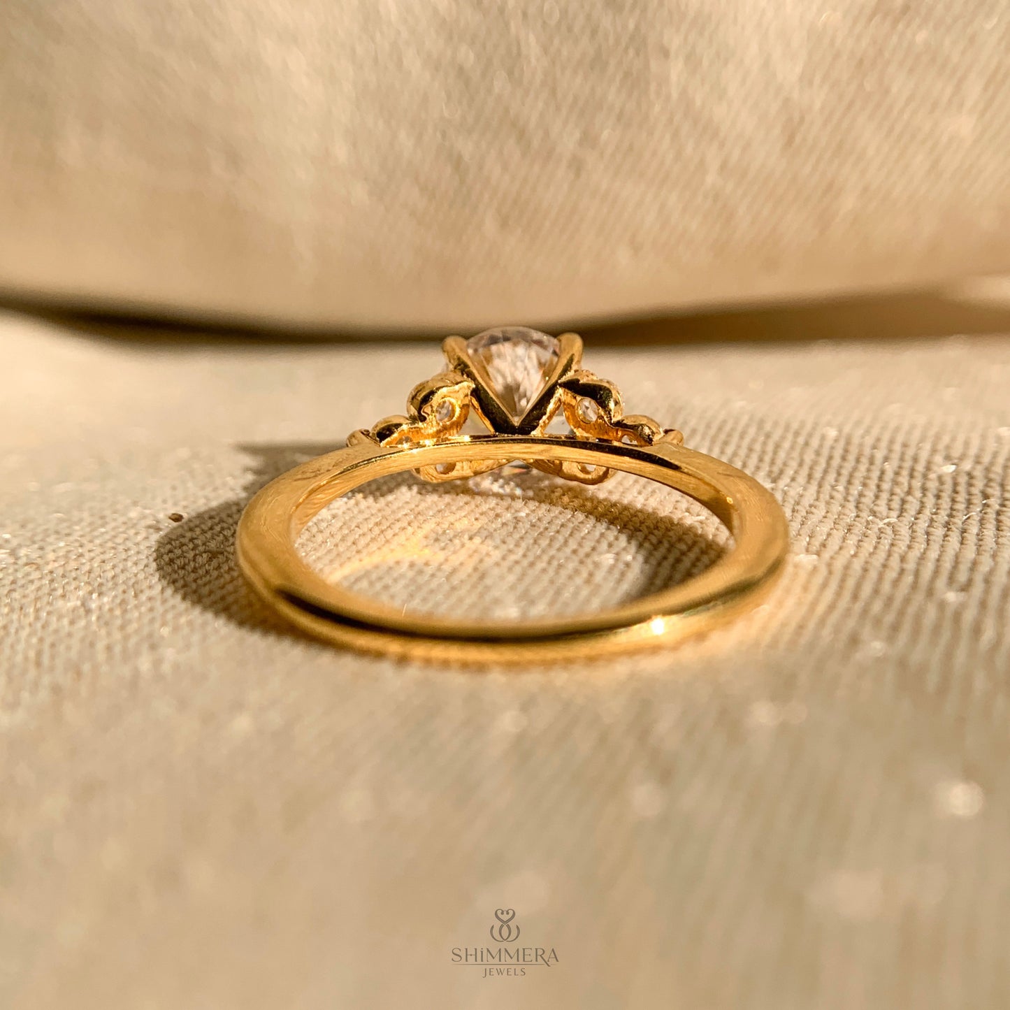 Timeless round cut bridal ring featuring side stones in white gold