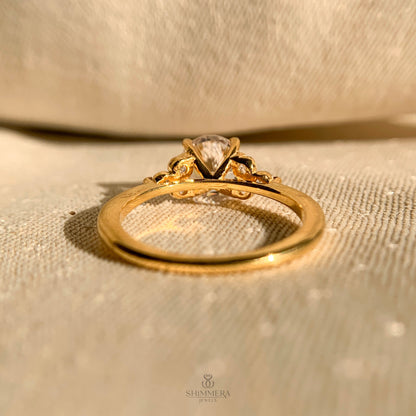 Timeless round cut bridal ring featuring side stones in white gold