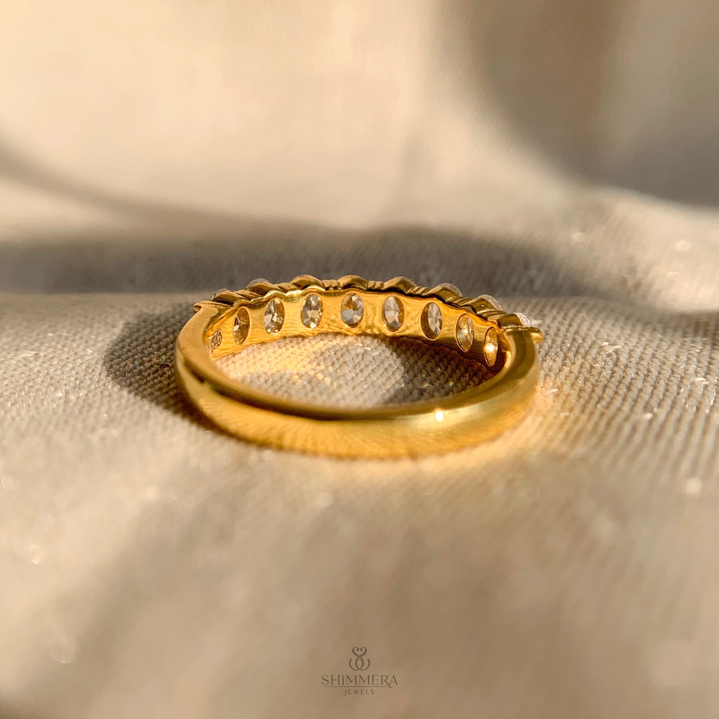 Timeless half eternity ring with oval diamonds in yellow gold setting
