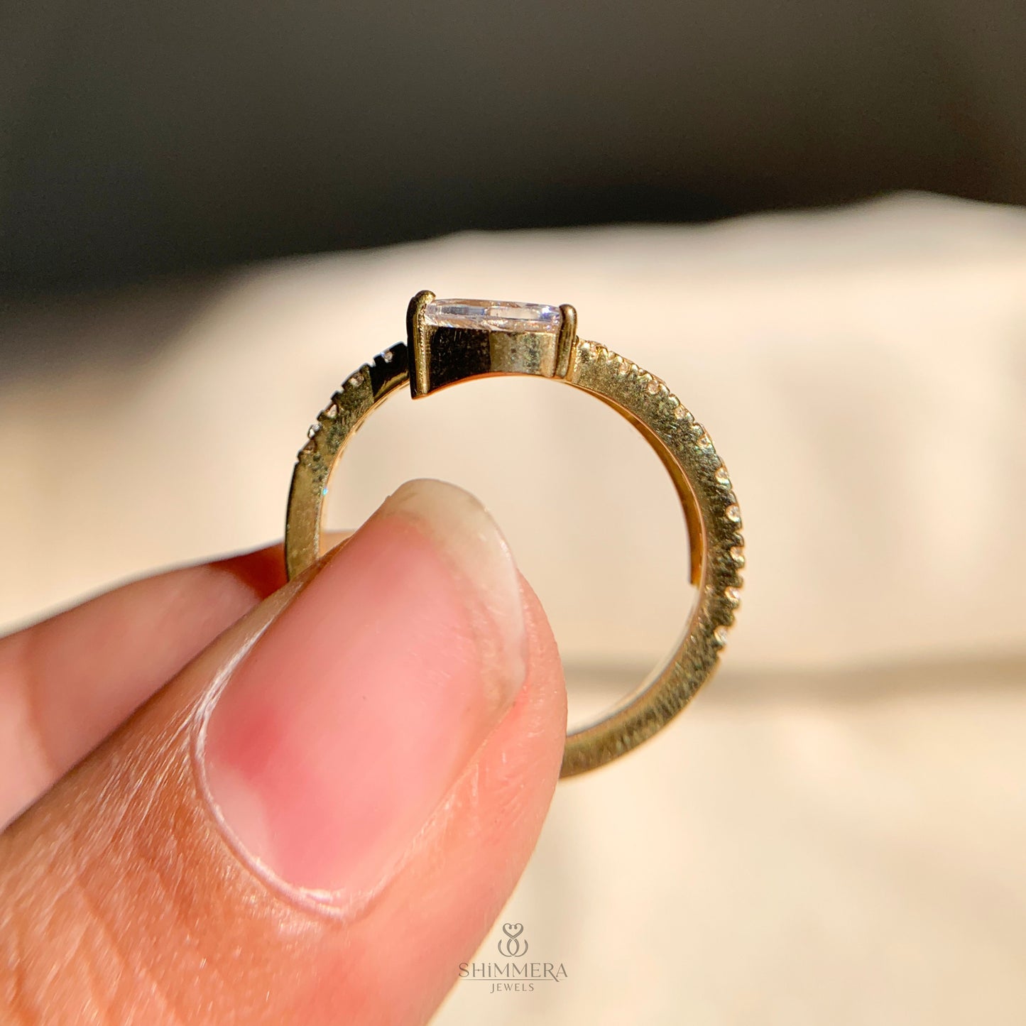 Stylish east west pear diamond engagement ring with twisting spiral design