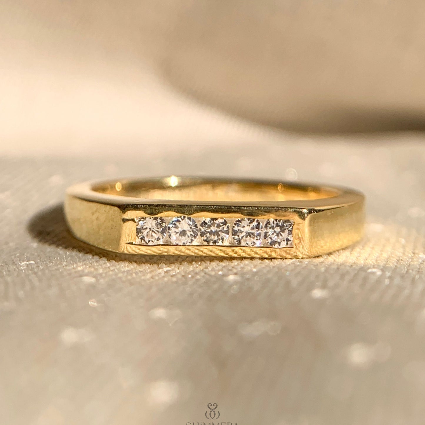 Thin yellow gold ring with five sparkling diamonds