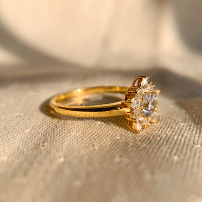 
“Floral cluster diamond engagement ring in yellow gold setting”